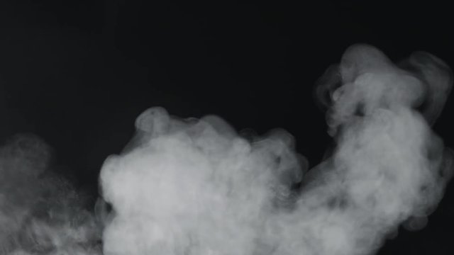 slow motion vapor steam rising over black background