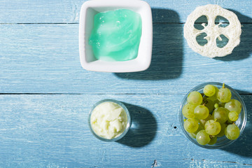 beauty product samples from grape seed ingredient, blue wooden table background