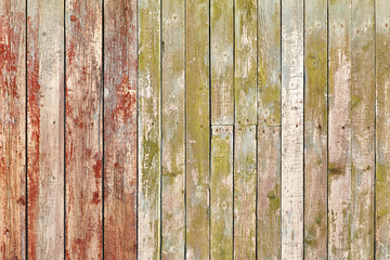 Old wooden background of vertical boards with peeling green and red colors