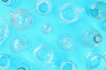 Glassware, glasses, jars on a pastel blue background. Flat lay, top view.