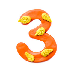 Plasticine number 3 with autumn leaves
