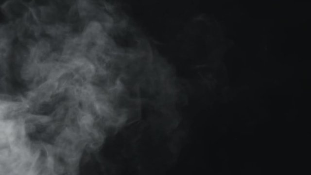 slow motion vapor steam from left side over black background