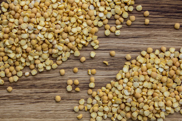 yellow chopped pea croup, on a brown wooden background, top view