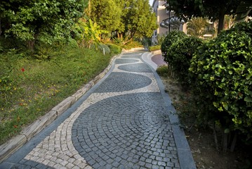 Cobblestone walk in the garden in summer