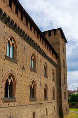 Fototapeta premium The facade of the Visconti Castle ( castello visconteo ). Medieval building with red brick facades in Pavia, Lombardy, Italy