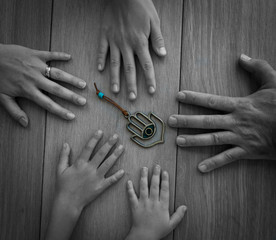 Isolated five hands of a family members on a wooden background 