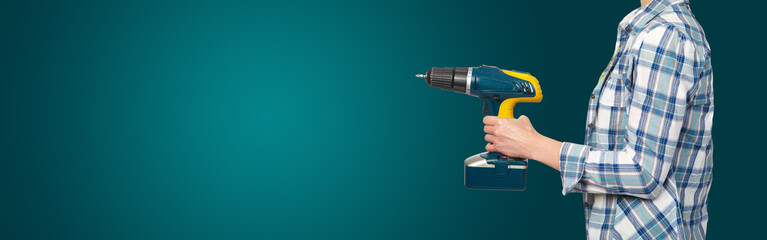 Woman with a drill on green background