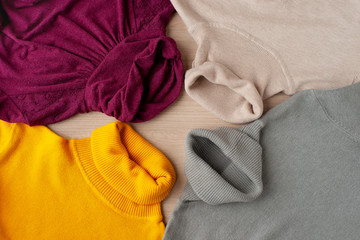 Multicolored classic turtlenecks. View from above. Clothes for autumn and winter in the form of a turtleneck. Knitted turtlenecks for the fashionable stylish female image.