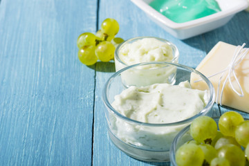 beauty products from grape seed ingredient, blue wooden table background