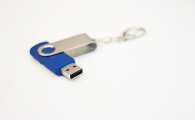Blue usb flash drive for saving information on a white background close-up