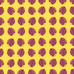 Tropical palm monstera leaves lies on a pastel colored paper. Nature summer concept pattern. Flat...