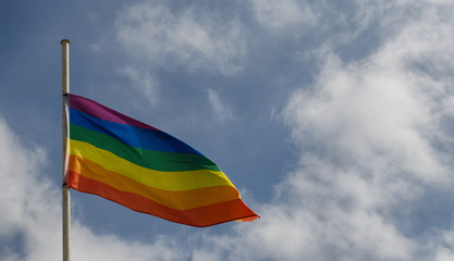 Gay flag on sky background
