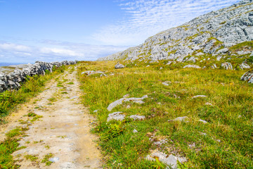 Rocks and trail over mountain in Burren way trail