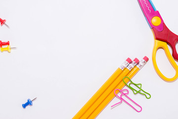 Two paper clips talking while lying on a white floor and on a pencil. Miniature school life and...