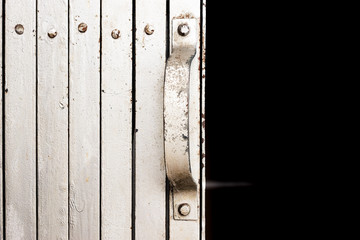 close up of metal folding door open into dark room