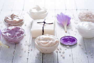 cosmetic cream variations, soap and bath salt with autumn crocus herbal flower on white wooden table