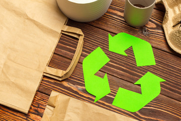 Eco concept with recycling symbol on table background top view