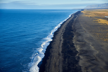 Fototapeta na wymiar View from the heights to the shore with black sand in Iceland