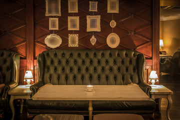 Fron view of green leather sofa in restaurant