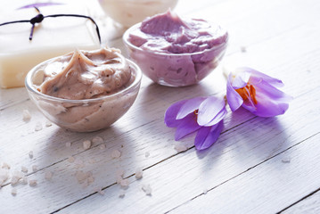 cosmetic cream variations, soap and autumn crocus herbal flower on white wooden table