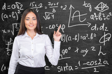 A portrait of a mixed race college student in a classroom