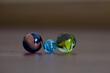 glass Marbles on dark wooden floor