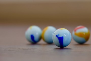 glass Marbles on dark wooden floor