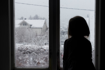 Little girl looking out of the window