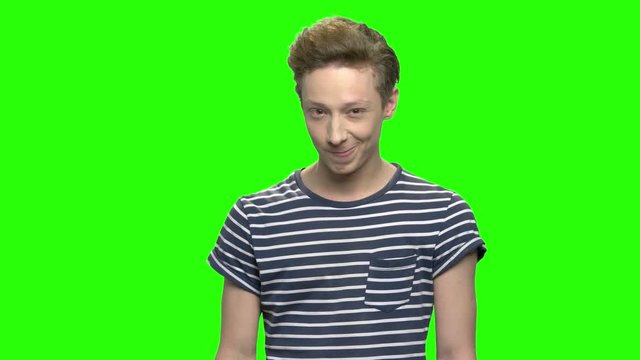 Young teenage boy, facial expressions. Green screen hromakey background for keying.