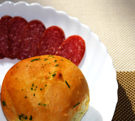 Rustic bread with herbs and salami sausage. Garlic buns.