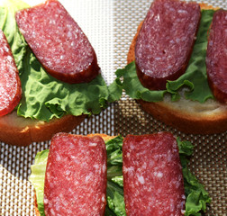 Rustic bread with herbs and salami sausage. Garlic buns. Sandwiches.