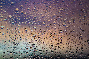 closeup of raindops on window in the evening