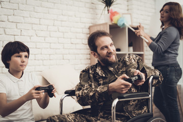 Paralyzed Male Soldier Plays Console With Sun.