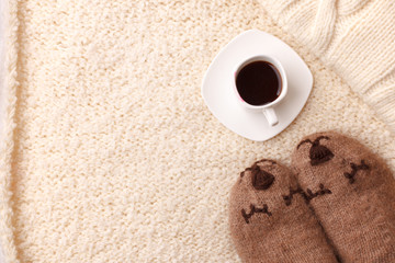 Warm soft blanket, cup of hot espresso coffee, woolen socks. Winter fall autumn cozy still life. Lazy weekend morning concept. Top view point. Copy space