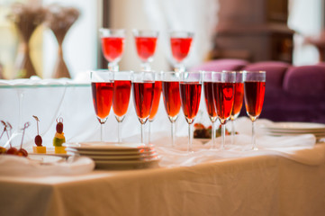 Glasses wih red drinks on the table