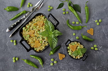 Pilav from bulgur with vegetables, carrots, green peas and fresh mint. Healthy food, vegetarian recipes