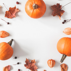 Autumn composition. Pumpkins, dried leaves on pastel gray background. Autumn, fall, halloween concept. Flat lay, top view, square, copy space