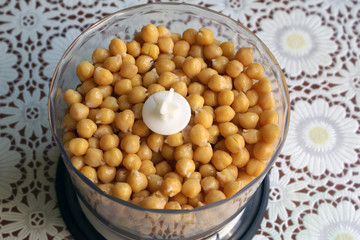 boiled garbanzo in a bowl of a blender, cooking hummus. Boiled chickpea close up. Source of protein for vegan healthy diet