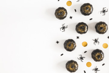 Hallowen decorations, black pumpkins on white background. Halloween concept. Flat lay, top view, copy space