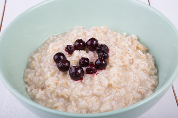 Oatmeal porridge served with blueberries