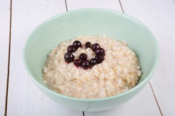 Oatmeal porridge served with blueberries