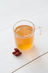 Glass mug of yellow herbal tea