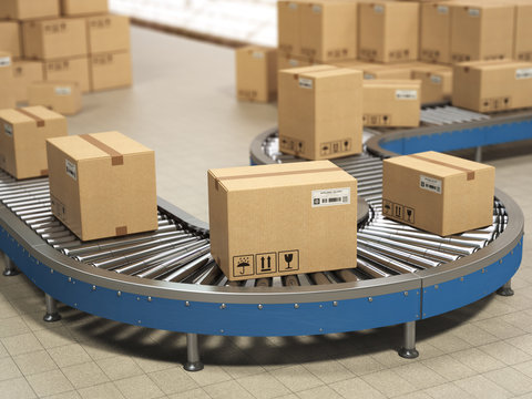 Cardboard boxes on conveyor roller in distribution warehouse, Delivery and packaging service concept.