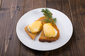 Fried toasts with baked egg and cheese