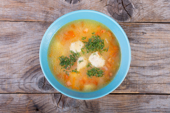 Vegetable soup served with herbs