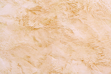 Decorative beige plaster on the wall.