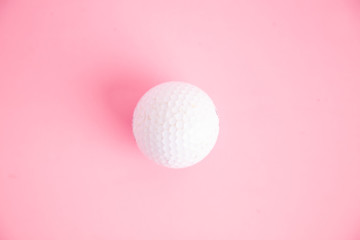 golf ball on pink background