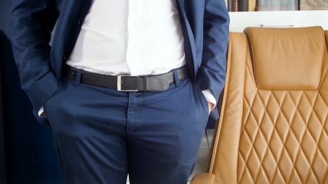 4k footage of young businessman standing at office and showing empty pockets. Concept of bankruptcy