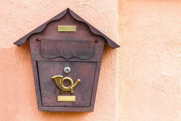 A beautiful mailbox hangs waiting for newspapers, parcels and letters.