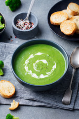 Broccoli cream soup in a bowl with toasted bread. Go green concept
